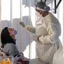 A woman receives a nasal swab, from a health worker wearing personal protective equipment (PPE), to be tested for COVID-19 at the Fourways Life Hospital in Johannesburg (Getty Images)