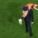 This picture taken on August 20, 2023 shows President of the Royal Spanish Football Federation Luis Rubiales carrying Spain's Athenea del Castillo Beivide on his shoulder as they celebrate winning the Australia and New Zealand 2023 Women's World Cup final football match between Spain and England at Stadium Australia in Sydney. 