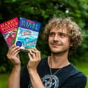 Max Roe with first edition copies of Harry Potter books his mum got him when he was young - one signed by JK Rowling could be worth £10,000.