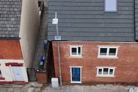 A builder in Ashton-under-Lyne built a house around a lamppost rather than wait for it to be moved. It will be moved at a later date 