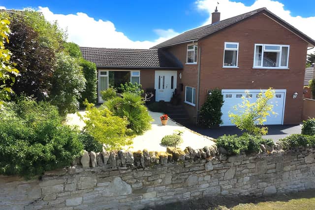 The detached Moor End Road home sits in a peaceful Radwell setting, with a raised front garden, driveway parking and a large garage