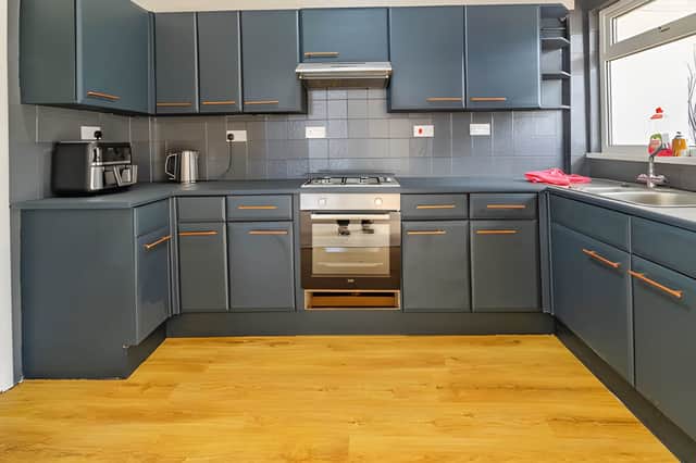 The stylish and modern kitchen offers a welcoming space with plenty storage