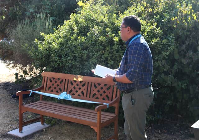 Reverend Thomas Samuel leading the service next to the donated bench.