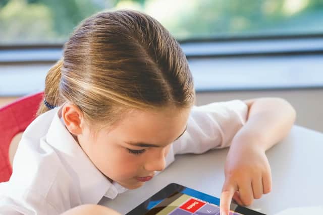 A pupil playing Times Table Rock Stars on a tablet