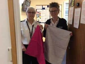 Enquiry office staff showing off the laundry bag