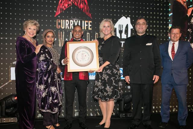 L - R: Broadcaster Angela Rippon, Jusna Begum, Surman Ali with the coveted award, Angela Richardson MP, President of CBI Lord Karan Bilimoria CBE and broadcaster Mike Bushell.
