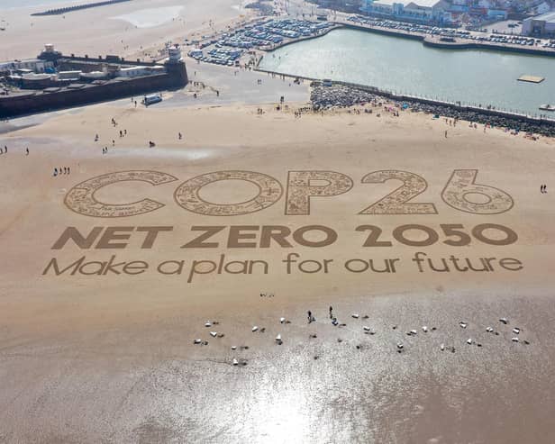 A giant sand artwork adorns New Brighton Beach to highlight global warming and the COP26 global climate conference