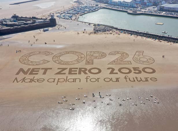 A giant sand artwork adorns New Brighton Beach to highlight global warming and the COP26 global climate conference
