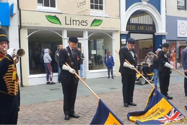 A bugler and Royal British Legion standard-bearers help mark the official opening