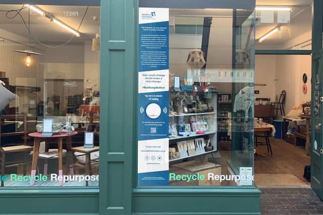 The Tap to Donate machine will be in the front window of IMPAKT Interiors in The Arcade