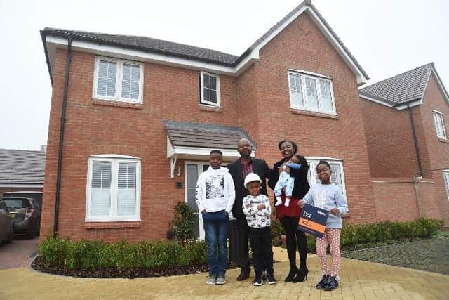 The Kingful family (Daniel, Marian, Nehemiah, Gabrielle, Jeremiah and Ramiah) at their new Bellway home at Brook View in Wixams