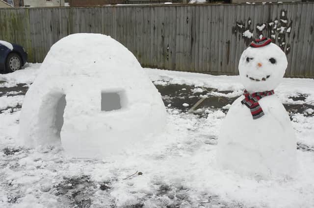 An igloo and snowman in Tunnard Street car park.
