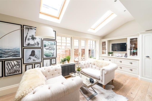 The family area has a part vaulted ceiling with Velux skylights, and glazed doors to the side