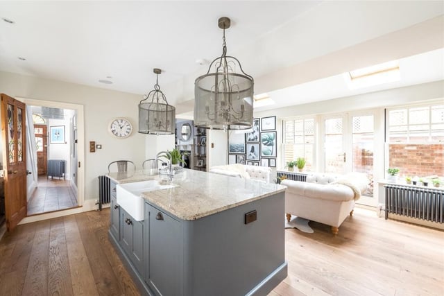 The kitchen/breakfast/family room is fitted in a bespoke range of hand built, hand painted units with granite work surfaces. The central island incorporates a breakfast bar and double bowl sink and drainer