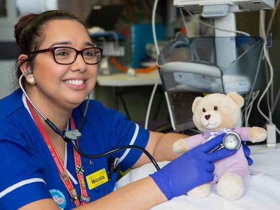 Sister Nicola Lane at Bedford Hospital has a listen to teddy's heart