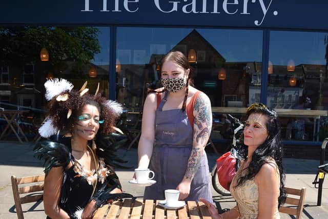 From left, Erika Graham and Ewa Spetana enjoy a coffee at The Gallery. Serving them is Natalia