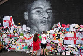 Messages of support and solidarity were left on the mural of footballer Marcus Rashford in Manchester, after it was defaced following England's Euro 2020 final defeat