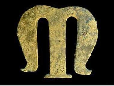 A copper-alloy grave letter ‘M’ recovered from a medieval hearth at the former Clarence Hotel on St John's Street
