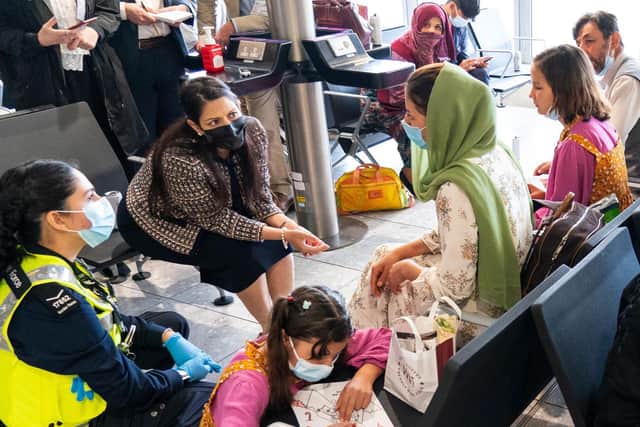 Home Secretary Priti Patel speaks to Afghan refugees at Heathrow Airport