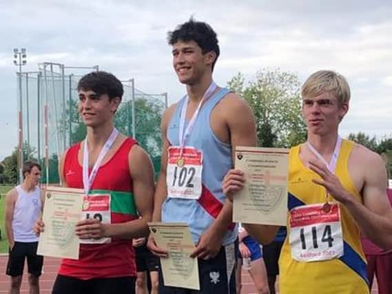 Champion Stephen Simmons (centre) on the podium after winning the English Schools decathon gold medal