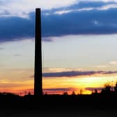 A dramatic sunset view of one of the chimneys