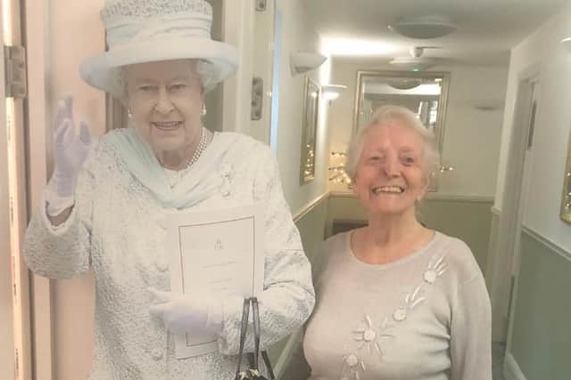 Residents had their photos taken with a cardboard cutout of the Queen