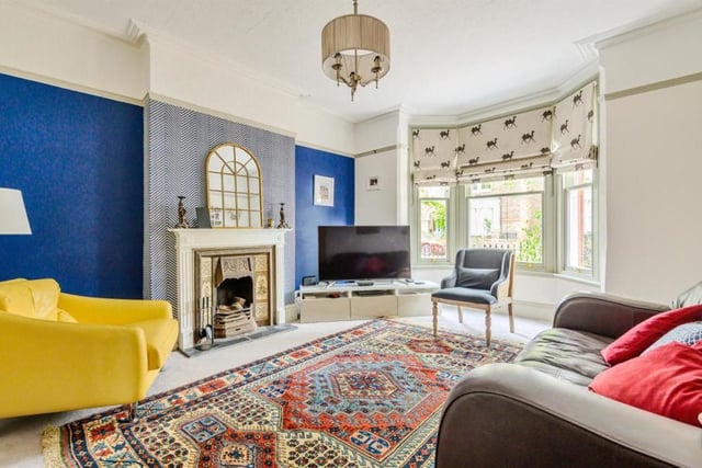 This room boasts a bay window and central cast iron tiled fireplace with interconnecting folding double doors to the family room