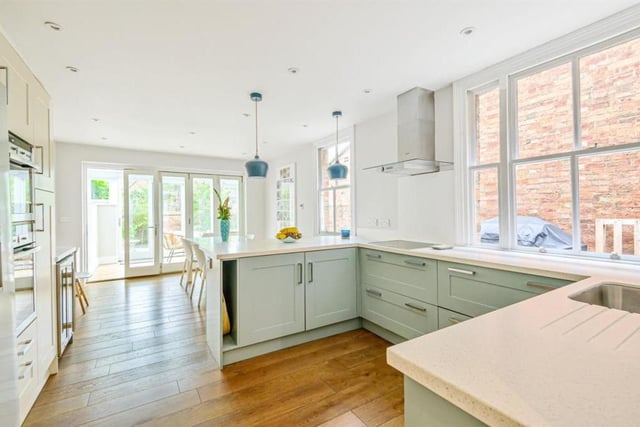 This light and airy fitted kitchen boasts light blue units, white worktops and integrated appliances. Bi-folding doors lead to a glass roof conservatory with bi-folding doors on to a patio area and walled south-facing rear garden as well as French doors on to the side courtyard