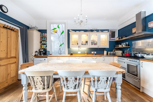 A wide aperture leads to the kitchen/dining area which has cream fronted Shaker-style units with hardwood work surfaces incorporating an inset sink. There is a range cooker with extractor over and space and plumbing for additional appliances
