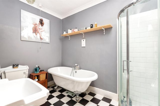 The family bathroom is fitted in a modern period style suite including a ball and claw footed bath and Velux skylight