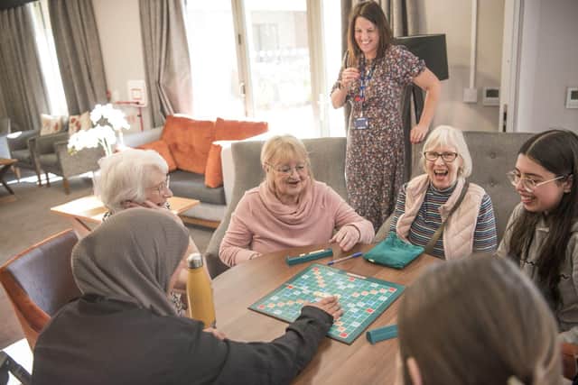 bpha Community Engagement Officer Fsella Afzal-Pagliari plays a game of scrabble with with Kimberley College students and Wootton Vale residents