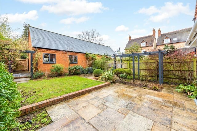 The landscaped rear garden faces south west, is walled on two sides and is designed for ease of maintenance. It has a flagstone outdoor entertaining area with a walled surround, a gazebo, and a raised lawn with an additional seating area and established borders. There is a garden shed. The detached double garage is accessed by twin security doors, and has been refurbished for potential use as a gym/games room