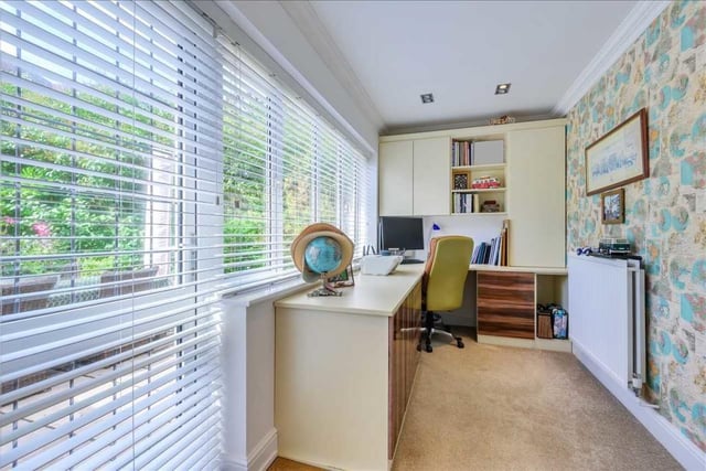 The generously-sized study has fitted furniture and overlooks the garden