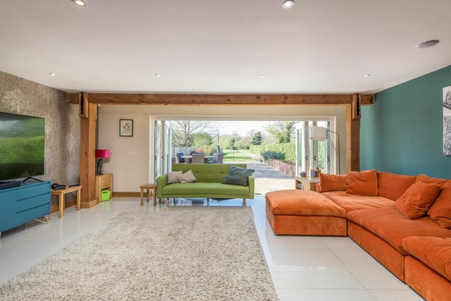 Across the reception hall is the lounge, where wow-factor awaits. Measuring 19ft 3in by 20ft 10in, it provides separation away from the front of the accommodation. The bi-fold doors open on to the patio