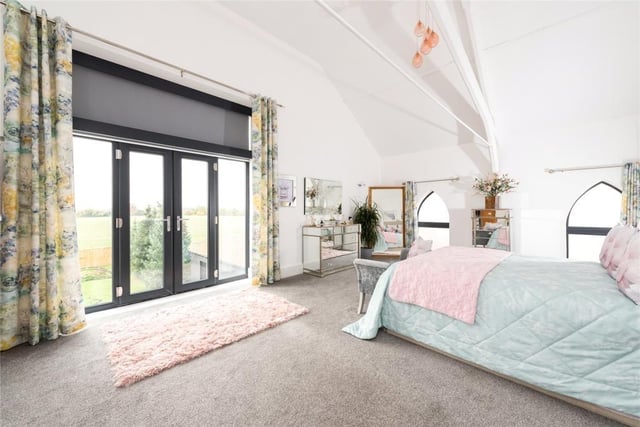 The master bedroom - which measures 23ft 2in by 14ft 4in - also has a walk-in wardrobe and a Juliet balcony with open views