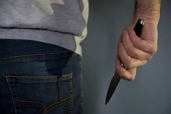 A model poses holding a knife. Picture: Andrew Matthews/PA