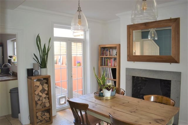 The dining room has a period open fireplace, double doors on to a low maintenance courtyard garden. There is also a cellar accessed via a door from the dining room