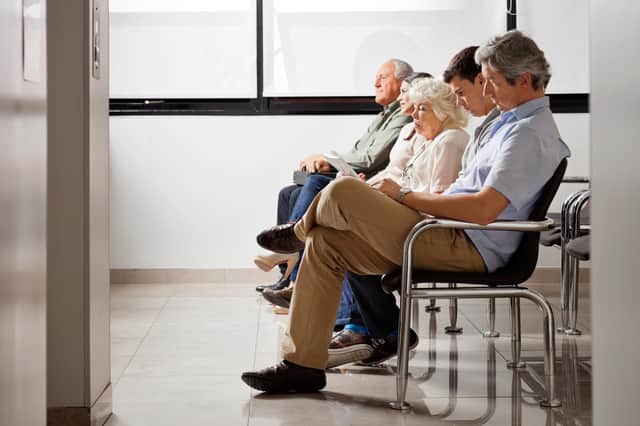 Row of multiethnic people sitting side by side while waiting for doctor in hospital lobby. Pic: Tyler Olson - stock.adobe.com