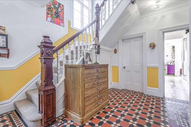 The spacious entrance hall has a stunning ceramic patterned tiled floor, stained glass window and original staircase with ornate balustrades and newel posts