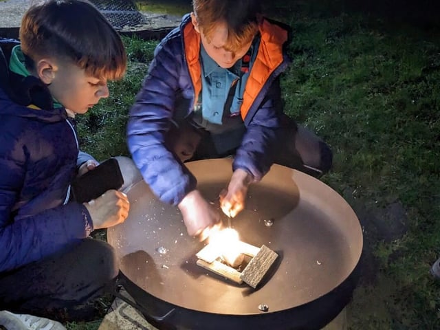 Two Scouts having a go at fire lighting