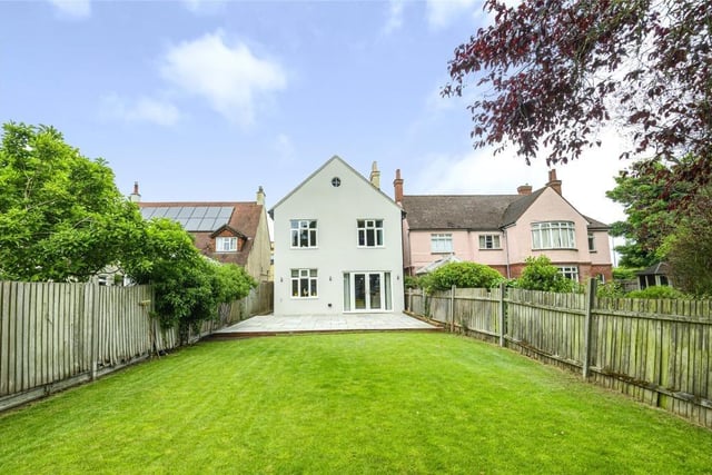 The south facing rear garden is mainly laid to lawn and has a detached home office/gym with a cloakroom