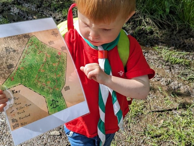 A Squirrel Scout holds a treasure map