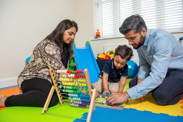 Muneeb and Maha playing with Haad in their converted playroom