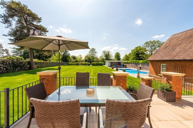 The rear garden is fully enclosed by timber fencing and has a raised paved terrace, accessed by doors from the kitchen/breakfast room and drawing room, for outside dining and entertaining. Steps down lead to the lawned garden which has mature trees interspersed