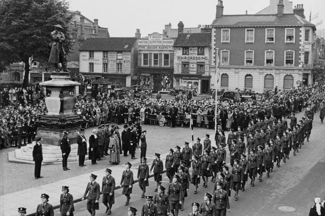 King Peter II of Yugoslavia takes the salute of the Women's Auxiliary Air Force (WAAF) as they march through the Bedford High Street past the statue of the 18th Century prison reformer John Howard during a parade on 13th June 1942 at St Pauls's Square in Bedford.