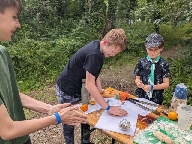 Scouts preparing dough for cooking outside