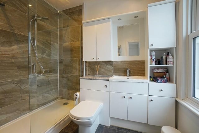 The sizeable en suite to the main bedroom boasts a large shower