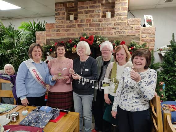 Aragon lacemakers receive People's Choice trophy for Best Adults' tree at Bedford Christmas Tree Festival 2022. Margaret Oakley, Festival Chair, far left