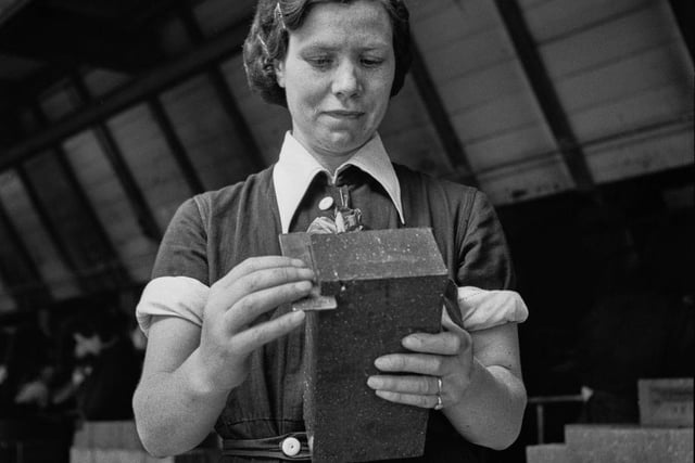 A woman war worker making bricks for the London Brick Company in Bedford during World War II, in August 1941.