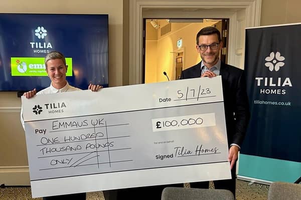 Charlotte Talott, CEO of Emmaus UK being presented with cheque by Mark Dilley, CFO of Tilia Homes